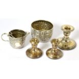 A Victorian Indian style silver sugar basin and milk jug and three dwarf candlesticks
