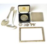 A group of silver including an Irish spoon, Dublin, a sauce ladle, photograph frame, cigarette case,