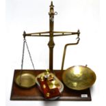A set of brass scales and modern postal scales with weights