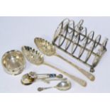 A George III silver toast rack, two berry spoons (later embossed) and a small silver bowl