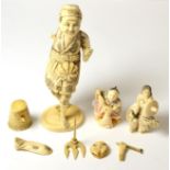 A Japanese Meiji period ivory okimono together with two netsukes circa 1910/20