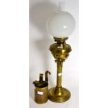 A 19th century brass columnar oil lamp together with a set of three graduating brass measures