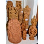 A group of twelve Eastern wooden carvings probably Indian of various Deities, birds, etc together