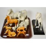 A small collection of Beswick horses including palomino and grey models