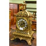 A pierced and gilt metal mantle clock, retailed by Miller & Son