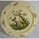A Leeds creamware dish, circa 1770, of shaped circular form, painted in colours with exotic birds in