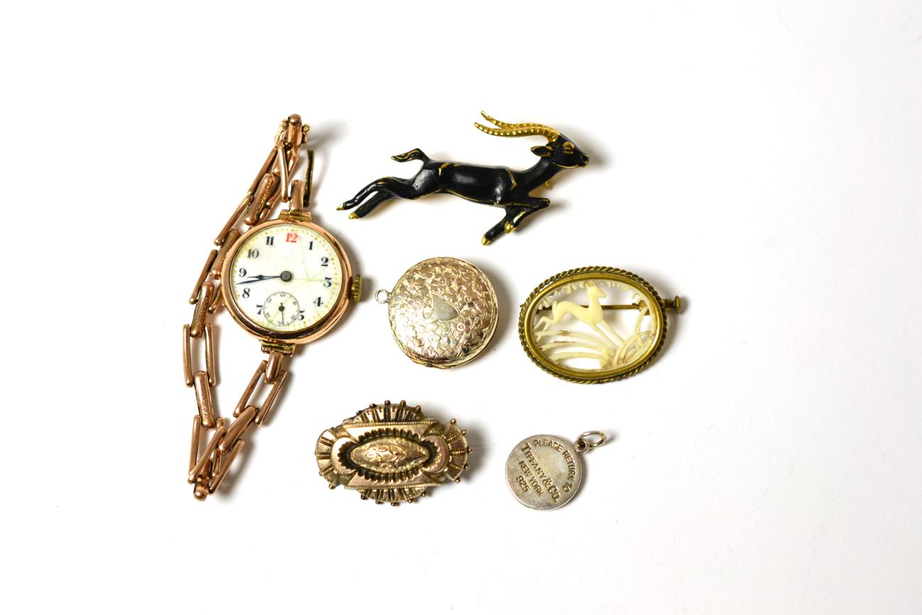 A lady's 9ct watch, Tiffany silver pendant, three brooches and a locket