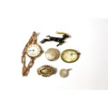 A lady's 9ct watch, Tiffany silver pendant, three brooches and a locket