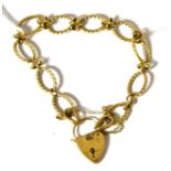 A fancy link bracelet with heart shaped padlock
