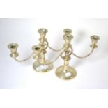 A pair of Middle Eastern white metal three light candelabra