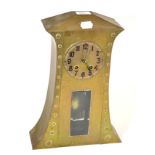 An Arts & Crafts hammered brass mantle clock