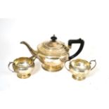 A silver three piece tea service