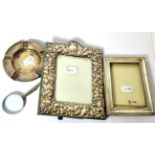 A pair of silver golf club ashtrays, two silver frames and a magnifying glass