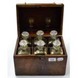 A George III mahogany six bottle decanter box, circa 1800, containing six gilt highlighted decanters