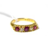 A ruby and diamond five stone ring on 18ct gold band
