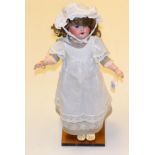 A French SFBJ bisque socket head doll, impressed '60' '4', with original brown wig, fixed blue eyes,