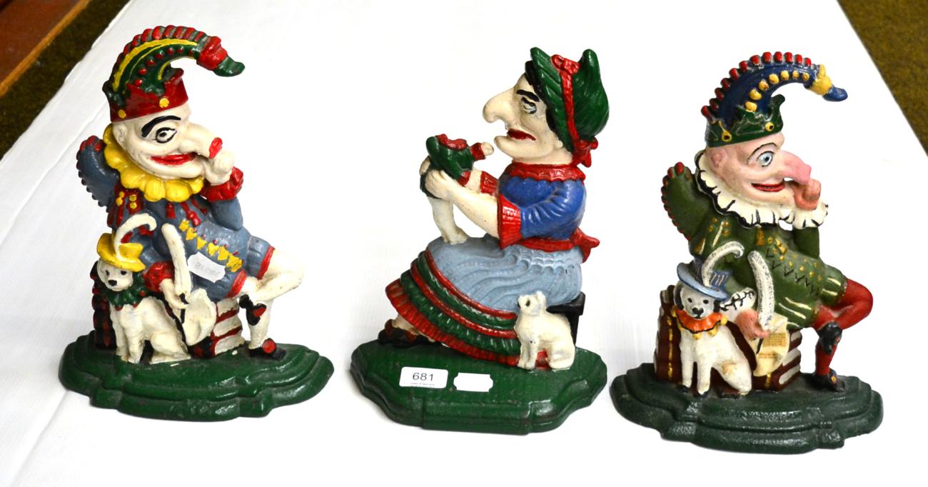 Three cast iron doorstops in the form of Mr Punch