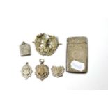 Silver card case, three silver fobs, silver stamp holder and a cap badge