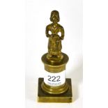An 18th century gilt reel (coin) holder in the form of a girl holding a hurdy-gurdy standing on a
