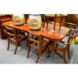 A reproduction twin pedestal dining table, together with six chairs (lacking seat pads), and a