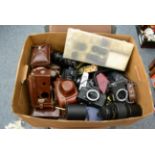 A collection of assorted cameras, lenses, flashes and accessories including two Rolleiflex SL35 E