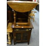 A small oak drop leaf occasional table and a small oak cupboard