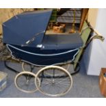 A navy blue Silvecross coach built pram