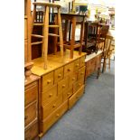 A modern pine multi-drawer chest, two trolleys, a three tier cake stand, pine stool, occasional