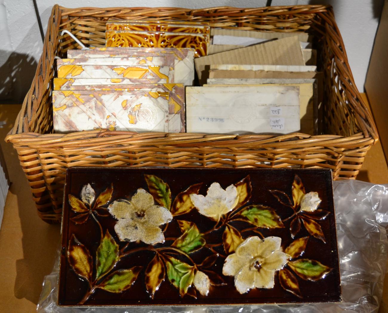Assorted Mintons Victorian and later tiles and a large brown glaze floral plaque
