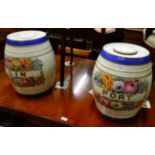 Two large floral painted pottery spirit barrels and covers