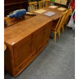 An Ercol suite comprising six Ercol chairs, an Ercol sideboard and an Ercol table