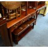 A reproduction mahogany three drawer side table, a similar console table on pad feet and a