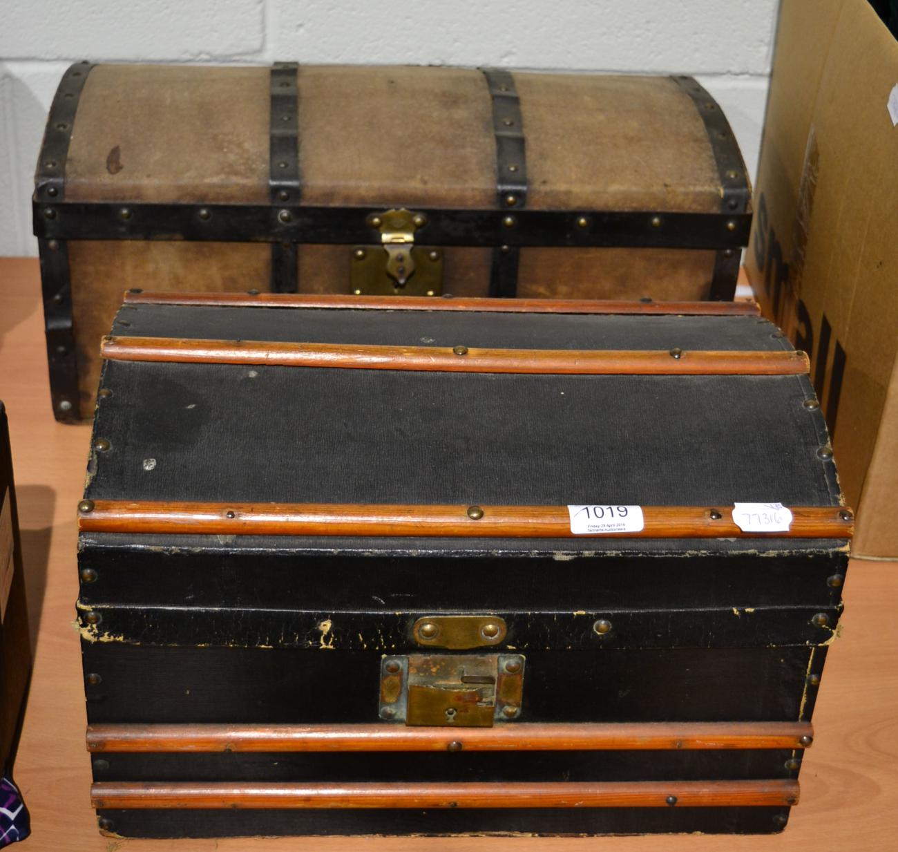 Doll's black canvas mounted domed trunk, with wooden straps and white paper lining; another with