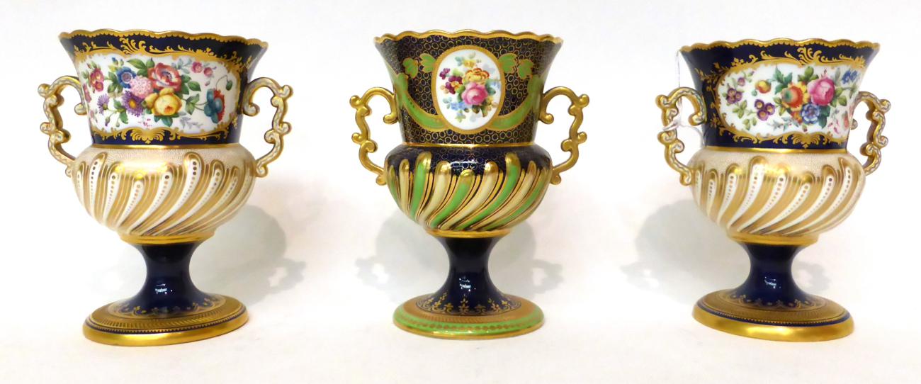 * A pair of Copeland blue ground twin-handled campana vases decorated with exotic birds in