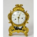 An ormolu striking mantel clock, case with scroll decoration, side sound frets, carrying handle, 4-