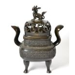 # A Chinese bronze incense burn and cover, the pierced cover surmounted by a dog of fo, the body