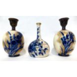 * A Doulton Burslem Flow Blue bottle vase, 21cm; and a pair of ovoid vases, 23cm (3)