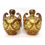 * A pair of Royal Crown Derby cream and claret ground twin-handled vases, gilt with Persian