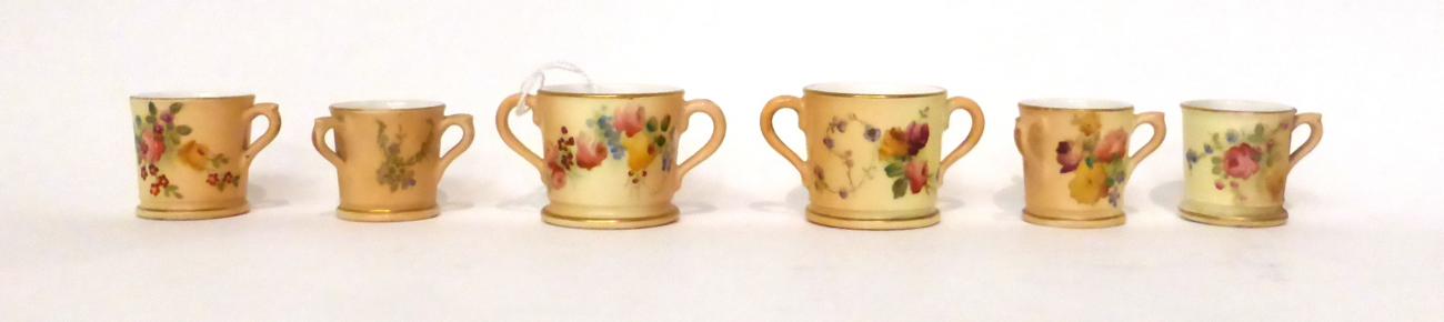 * Two Royal Worcester blush ivory miniature loving cups, 4cm; two similar miniature tygs, 3.5cm; and