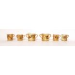 * Two Royal Worcester blush ivory miniature loving cups, 4cm; two similar miniature tygs, 3.5cm; and
