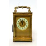 * A brass carriage timepiece, circa 1910, carrying handle, enamel Arabic chapter ring, single barrel