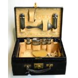 A leather cased travel set, with cut glass bottles and silver mounts, the lid stamped B.D.S (