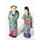 A pair of Chinese porcelain figures of a man and woman with famille rose decoration, 19.5cm high