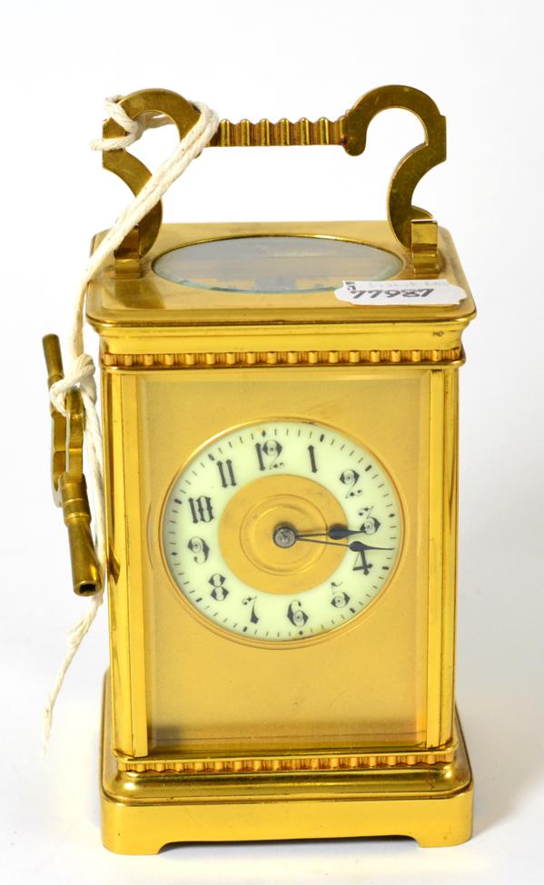 A brass striking carriage clock, circa 1900, carrying handle, enamel Arabic chapter ring, twin