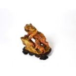 A Chinese carved soapstone tiger and cub, Qing Dynasty, 1750-1850, 11cm high, with hardwood stand