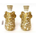 * A pair of Royal Crown Derby baluster vases with animal handles gilt with birds amongst foliage,