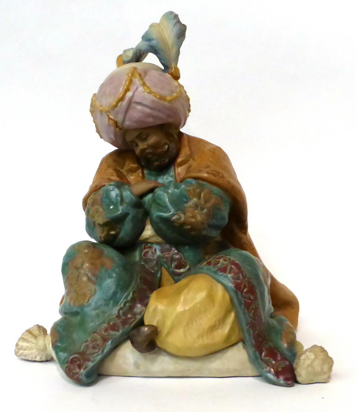 * A Lladro bisque figure of a seated Persian gentleman, 28cm high