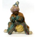 * A Lladro bisque figure of a seated Persian gentleman, 28cm high
