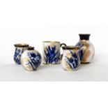 * A Royal Doulton Flow Blue miniature mug, 5.5cm; two similar mugs, 5cm; a similar vase, 7cm; and