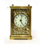 * A brass carriage timepiece, circa 1910, carrying handle, enamel dial with Arabic numerals and